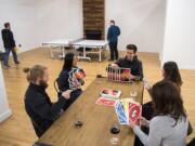 CoLab members play Jumbo Uno during a weekly CoLab happy hour in their new event space, Tandem Hall, behind Boomerang Coffee in downtown Vancouver.