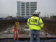 Project superintendent James Fuller of Kirkland Construction Group looks over the future site of the Kirkland Tower and Hotel Indigo, which includes the tower crane base, in yellow, Wednesday afternoon.