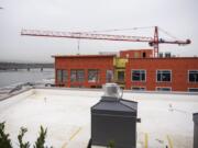 The crane for the Riverwest apartment building came in below the height limit, but it sits very close to the roof of the finished structure.