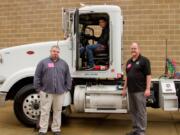 Woodland: Tribeca Transport truck driver Brad Cushman, and Eric Thwaites, chief operating officer, right, show Woodland High School student Shaun Sadlier, center, some of the features of one of their tractor trailers at the inaugural Woodland Days Career Fair, organized by Woodland Public Schools and the Port of Woodland.