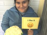 Sifton: Sifton Elementary School student Kimberly Reyes holds cauliflower, the featured ingredient of the month in Evergreen Public Schools’ Harvest of the Month program.