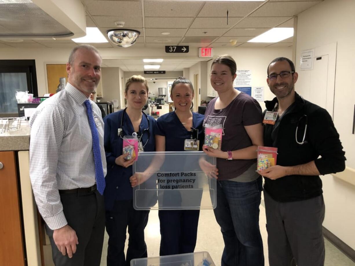 Kristen Fugiel, fourth from left, drops off comfort packs at PeaceHealth Southwest Medical Center in Vancouver for mothers who have experienced pregnancy loss. Fugiel and MOMS Club of Vancouver-Southwest Washington donated 100 packs to PeaceHealth to help mothers navigate the grief that accompanies a miscarriage.