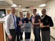 Kristen Fugiel, fourth from left, drops off comfort packs at PeaceHealth Southwest Medical Center in Vancouver for mothers who have experienced pregnancy loss. Fugiel and MOMS Club of Vancouver-Southwest Washington donated 100 packs to PeaceHealth to help mothers navigate the grief that accompanies a miscarriage.