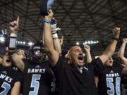 Hockinson coach Rick Steele and his team celebrate after winning their second straight 2A state football championship game on Saturday, Dec. 1, 2018, in Tacoma, Wash. Hockinson defeated Lynden 42-37.