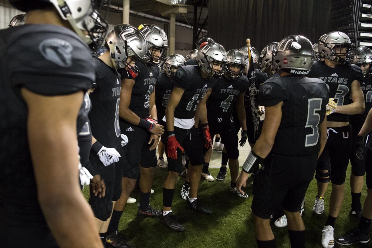 Union gathers on the sidelines before running onto the field before the Class 4A state football championship game against Lake Stevens on Saturday, Dec. 1, 2018, in Tacoma, Wash.