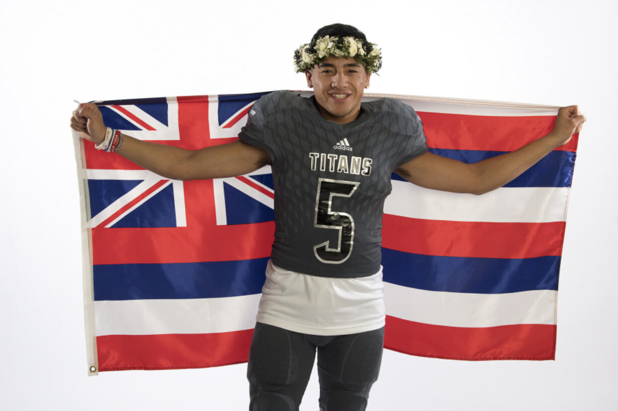 Union quarterback Lincoln Victor drapes the flag of Hawaii around his shoulders. Victor was born in Hawaii and moved to Vancouver with his familly when he was a toddler.