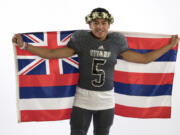 Union quarterback Lincoln Victor drapes the flag of Hawaii around his shoulders. Victor was born in Hawaii and moved to Vancouver with his familly when he was a toddler.