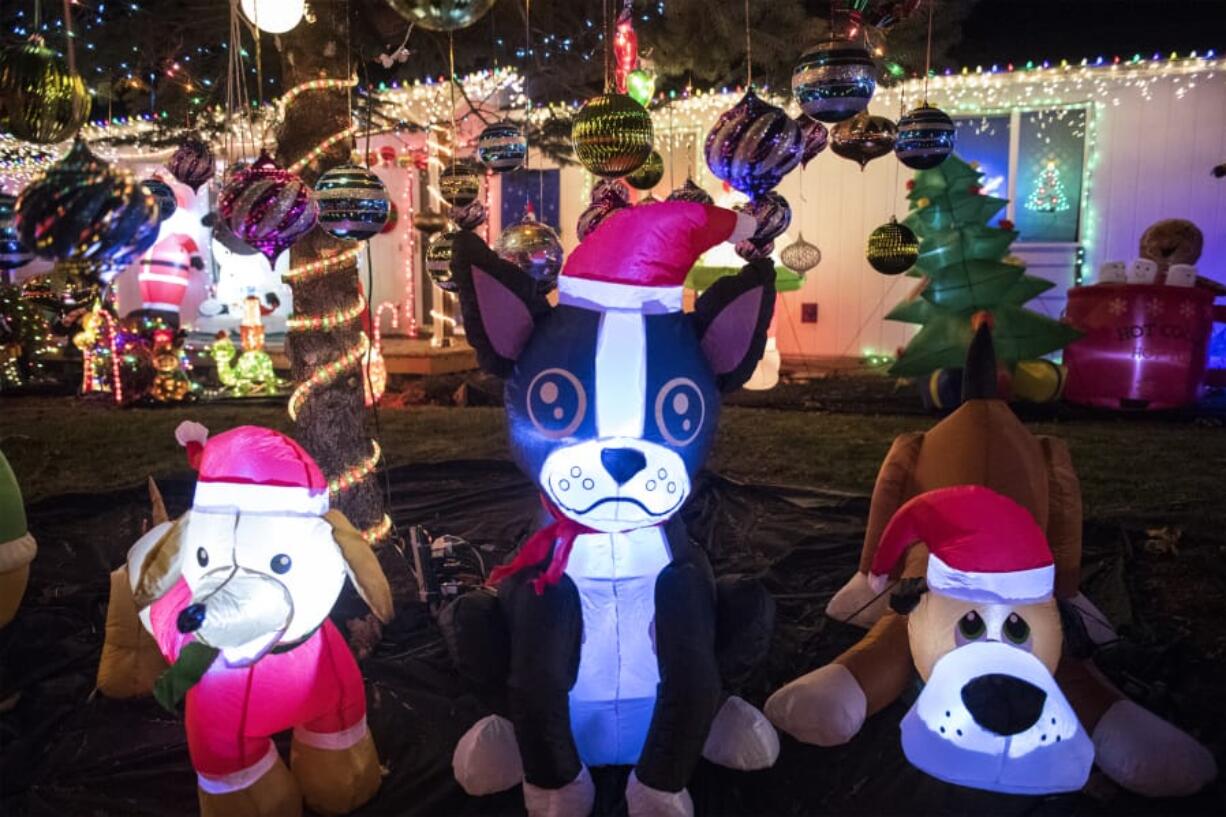 Cathy McGuire’s inflatable “dog pound,” one section of her yard full of Christmas inflatables and decorations.