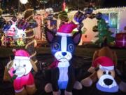 Cathy McGuire’s inflatable “dog pound,” one section of her yard full of Christmas inflatables and decorations.