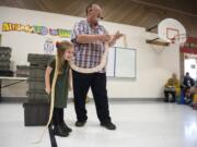Scarlet Ferguson, Glenwood Heights Primary School kindergartener, lets a reticulated python rest around her neck during Richard Ritchey's Reptile Man presentation at Glenwood Heights Primary School in Vancouver on Dec. 6, 2018.