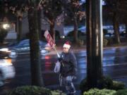 Kelly Olson, a paraeducator at Hazel Dell Elementary School, walks during a rally in front of the Vancouver Public Schools’ offices on Tuesday night.