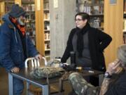 Jack Crowley, left, talks with Jamie Spinelli, center, a case manager with Community Services Northwest, at the Vancouver Community Library on Dec. 11. As part of a new pilot project, Spinelli works in the library every Tuesday morning to help connect homeless people, like Crowley, with resources. “The library staff here are excellent, but they’re also not social workers,” Spinelli said.