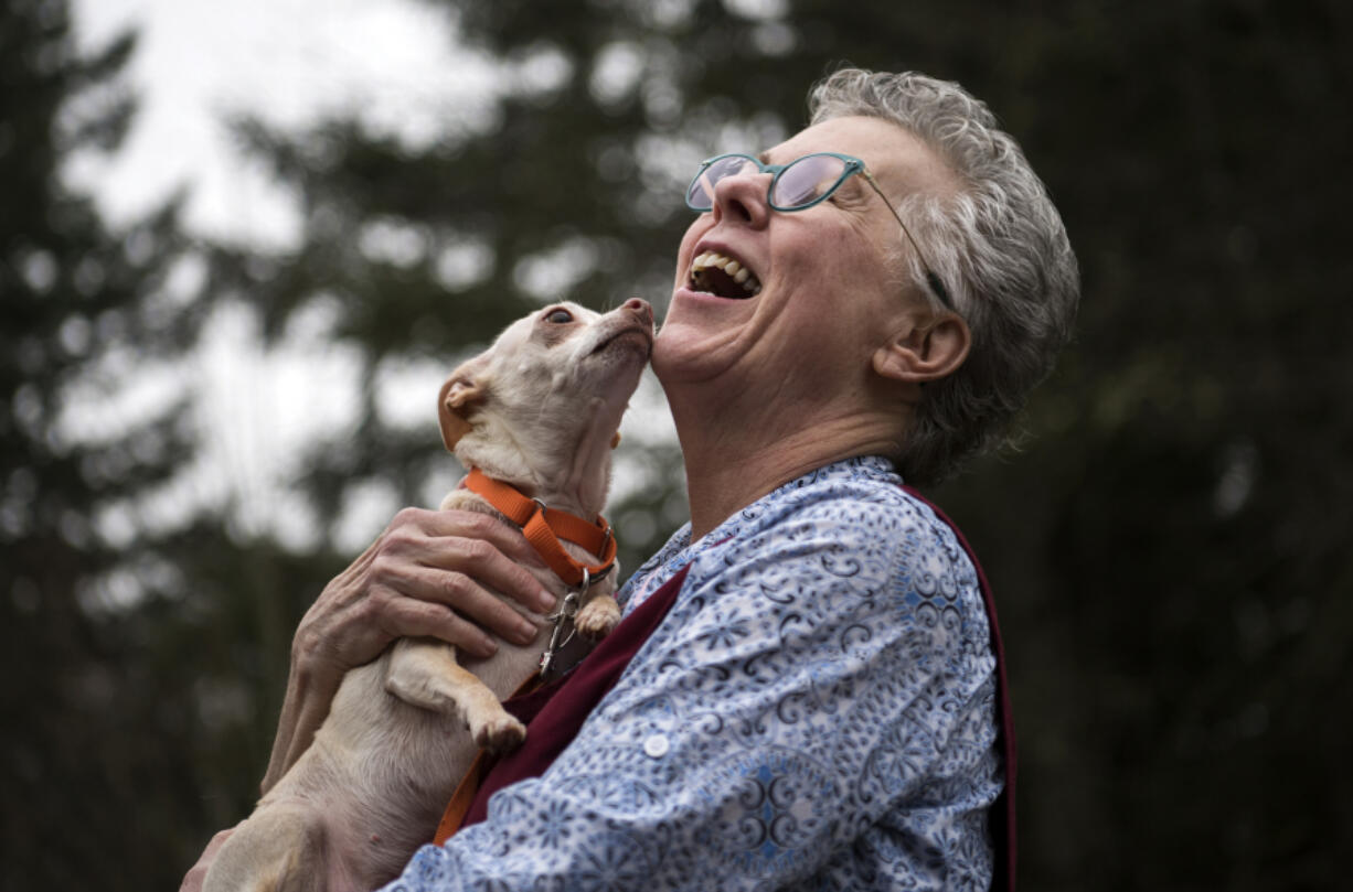 Volunteer Rosie Star shares a moment with Carly as they play outside at the Humane Society for Southwest Washington.