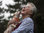 Volunteer Rosie Star shares a moment with Carly as they play outside at the Humane Society for Southwest Washington.