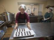 Pamela Wanous, left, and Ann Wanous, co-owners of Whimsy Chocolates, prepare a batch of salted caramels in Whimsy’s kitchen in Battle Ground.