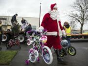 Doug Morris, with Waste Connections, helps unload a truck of 200 bikes for the annual Scott Campbell Christmas Promise at Washington Department of Social and Health Services in Vancouver on Tuesday.