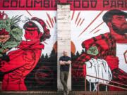 Alex Mickle, founder of the Columbia Food Park, stands in front of a new mural that adorns the eastern wall of the Columbia Food Park, painted by Portland artist Jonathan Case.