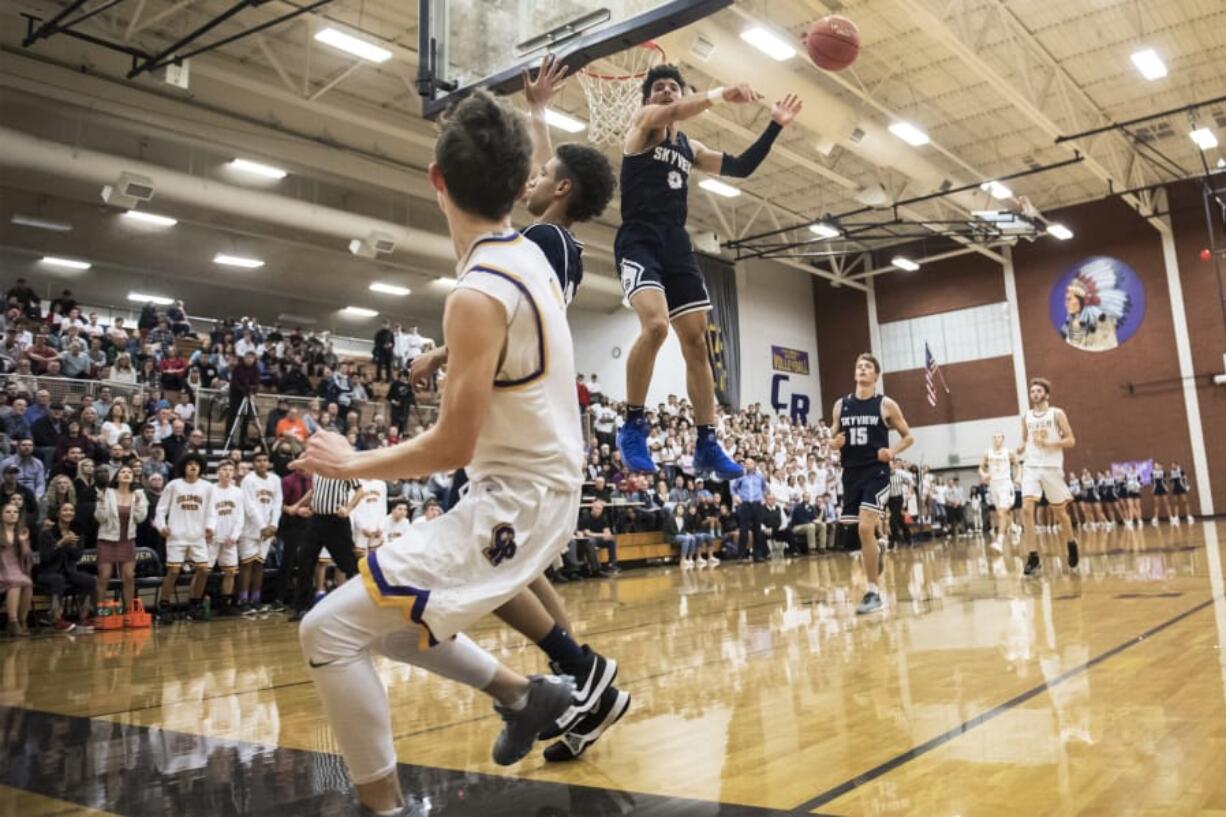 Skyview’s Alex Schumacher blocks a shot by Columbia River’s Nate Snook during Friday’s non-league game at Columbia River High School.