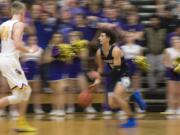 Skyview's Alex Schumacher takes the ball up the court against Columbia River during a match at Columbia River High School on Friday night, Dec. 14, 2018.