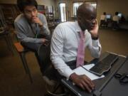 Tola Atewologun helps recent Chief Sealth graduate Gonzalo Cruz, 18, secure entrance loan counseling for college. Ellen M.