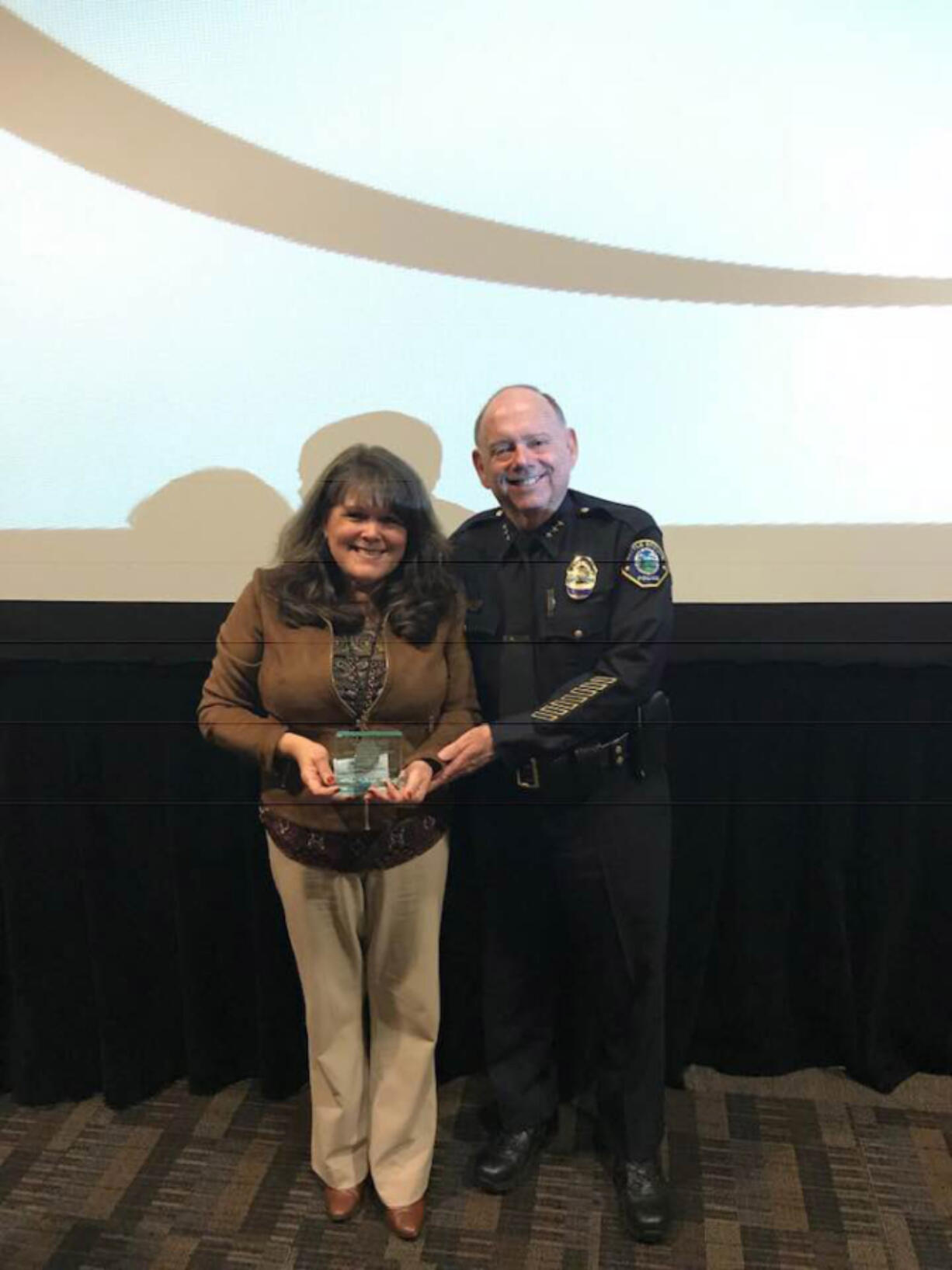 Battle Ground: Kathy Deschner accepting a Prevention Professional of Excellence Award at the 2018 Washington Prevention Summit from Battle Ground Police Chief Bob Richardson.