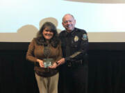 Battle Ground: Kathy Deschner accepting a Prevention Professional of Excellence Award at the 2018 Washington Prevention Summit from Battle Ground Police Chief Bob Richardson.