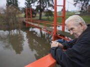 Denny Heasley catches his breath while walking down to the Golden Gate Bridge replica at his home in Ridgefield. The bridge is 110 feet long and 17 feet high. In the decade since the bridge went up, the Heasleys have received a number of visitors.