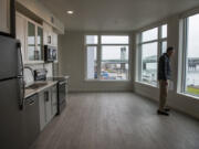 Jim Edwards, Gramor Development project director, views the Columbia River from a one-bedroom apartment at the new Rediviva apartment building at The Waterfront Vancouver. The building opened to tenants last week.