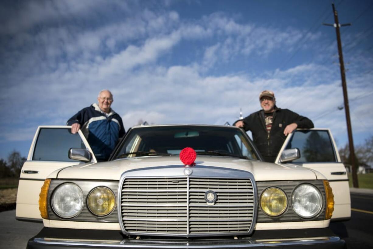 Glenn Tribe, left, and his son Mike get into Mike’s car after attending the ceremony to commemorate the new bridge that will carry traffic on Northeast 10th Avenue over Whipple Creek on Tuesday. A crocheted red Rudolph nose covers the hood ornament on the car. Mike Tribe’s friend makes these yarn accessories for different holidays to put on hood ornaments and RV hitches.