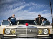 Glenn Tribe, left, and his son Mike get into Mike’s car after attending the ceremony to commemorate the new bridge that will carry traffic on Northeast 10th Avenue over Whipple Creek on Tuesday. A crocheted red Rudolph nose covers the hood ornament on the car. Mike Tribe’s friend makes these yarn accessories for different holidays to put on hood ornaments and RV hitches.