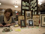 Jennifer Fuller, of Washougal, owner of Jennifer’s Vintage, works in her booth at the Holiday Vendors Market at the Vancouver Elks Lodge 823 in Vancouver. This was the first year for the market, which featured 30 booths with handmade art.