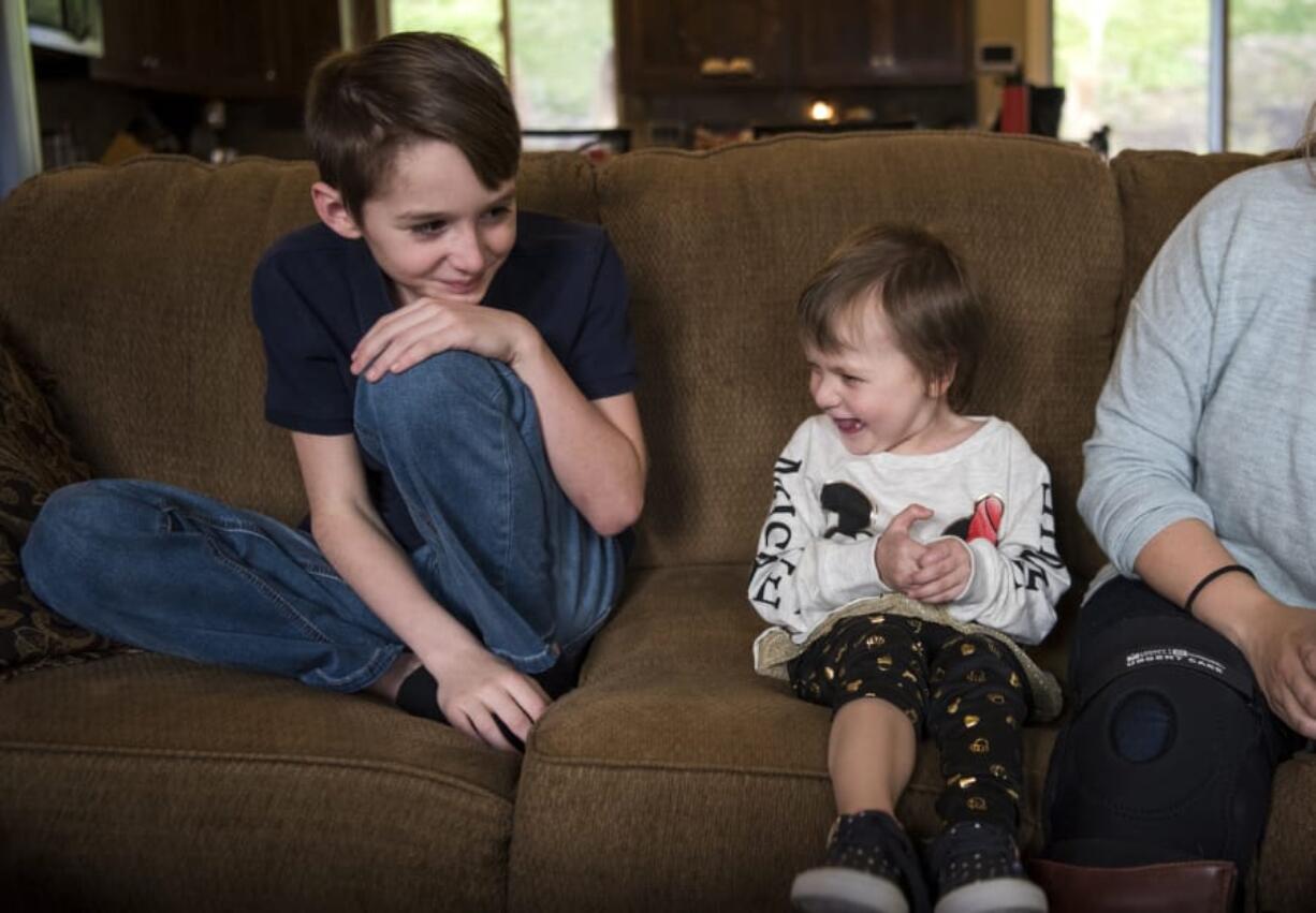 Matthew McDonnell, 11, sits with Summer Worthington, 3, at his home in Washougal. Last year, Matthew set up a hot chocolate stand to raise money for Summer when she was in the hospital battling cancer. This year, Matthew decided to set up his stand again to brighten another family’s holiday season.