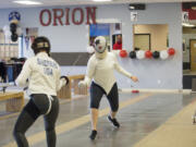 Jazzy Shepard, left, spars with Kaela Meeham at Orion Fencing on Sunday afternoon. Orion Fencing in Orchards held a free open house over the weekend.