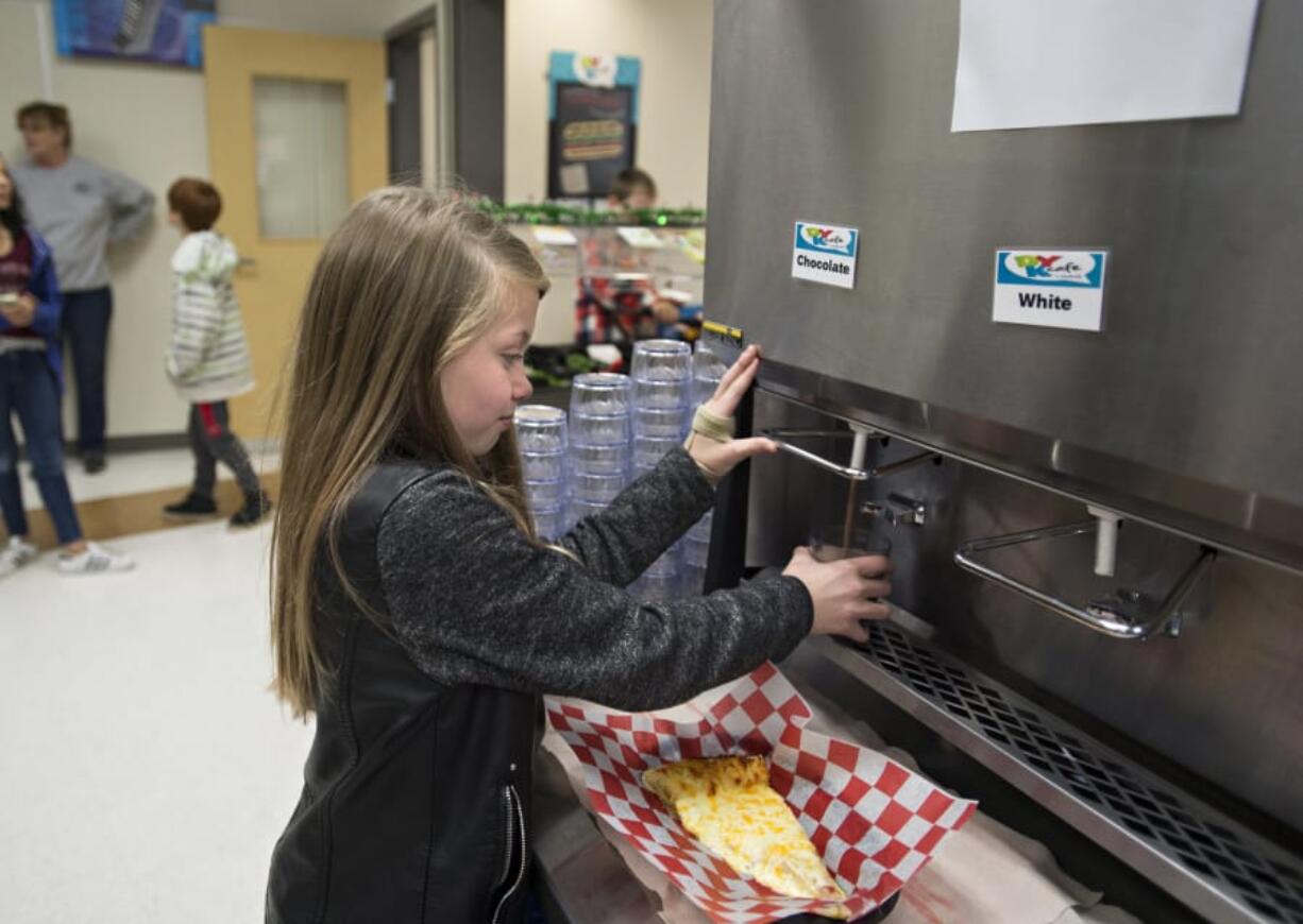 Fifth-grader Kelsey Bisconer, 11, fills up her glass with fresh chocolate milk during lunchtime Tuesday morning at Laurin Middle School. Clark County Green Schools received a $40,000 grant from the Washington Department of Ecology to install the dispensers at schools in Clark County.