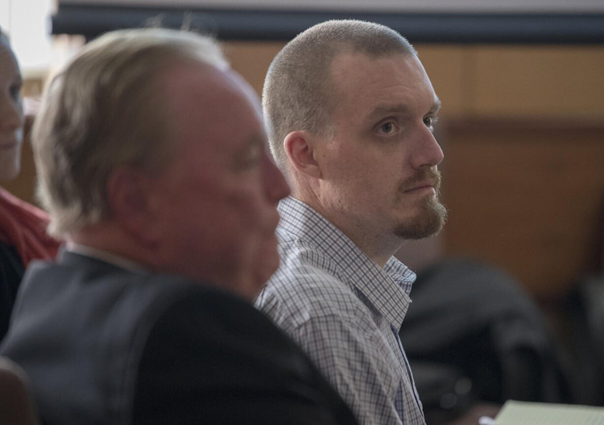 Todd Marjama Jr., right, who is accused of killing his wife, listens to opening statements Nov. 27 in his murder trial in Clark County Superior Court. The case went to the jury Wednesday evening.