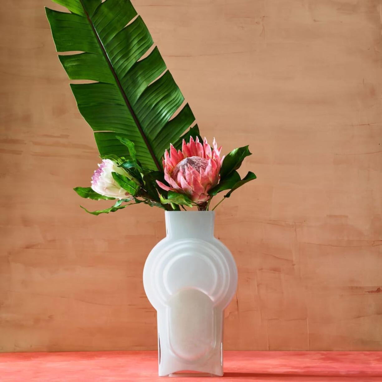 A 16-inch retro encased glass vase in cased white.