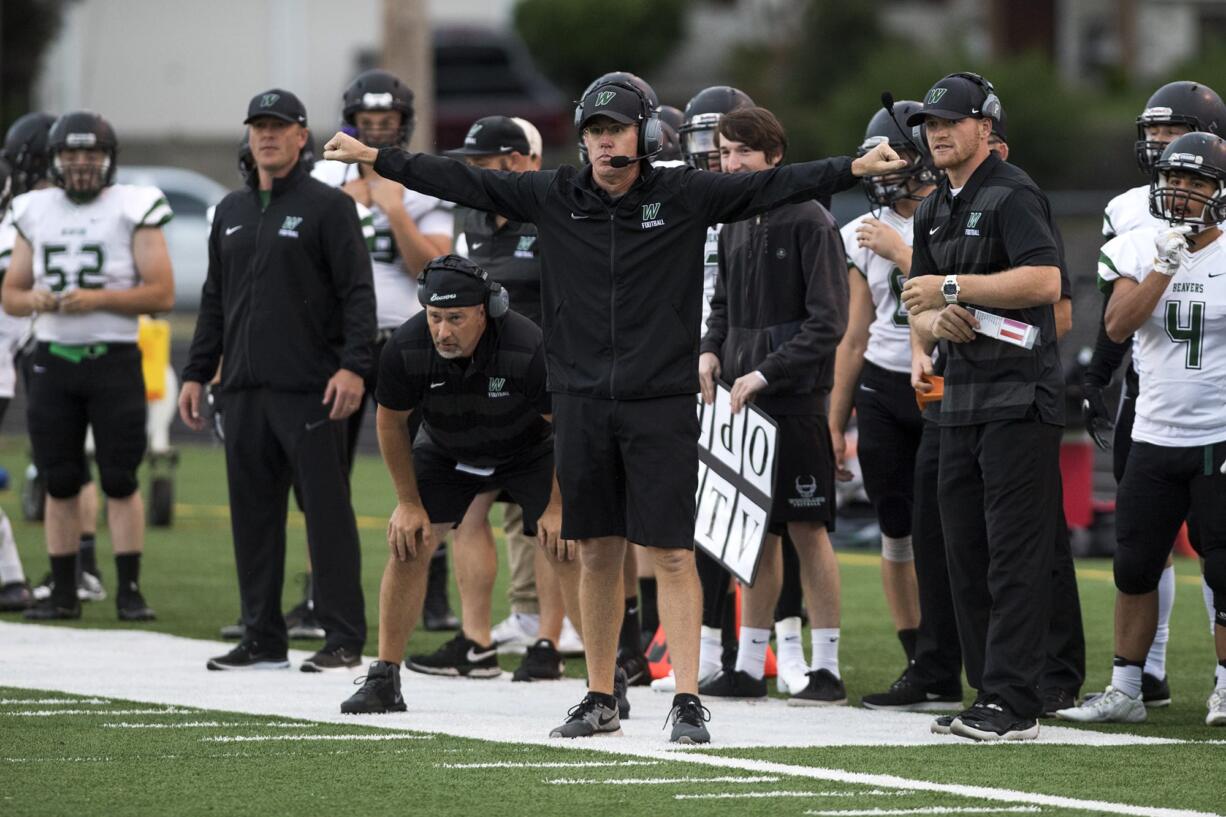 Woodland coach Mike Woodward signals to his team during the 2A Greater St. Helens League opener at Washougal High School on Friday, Sept. 14, 2018.