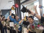 English Under the Arches graduates celebrate following a ceremony on Monday at the McDonald’s at 2814 N.E. Andresen Road.