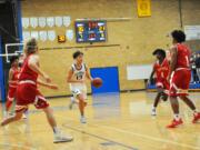 Four Fort Vancouver defenders collapse in the lane at Mountain View guard Sam Frosh drive to the hoop during the Thunder's 79-50 win on Tuesday night at Mountain View High School.