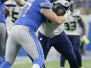 Seattle Seahawks defensive tackle Poona Ford, right, is blocked by Detroit Lions offensive guard Frank Ragnow (77) during the second half of an NFL football game, Sunday, Oct. 28, 2018, in Detroit.