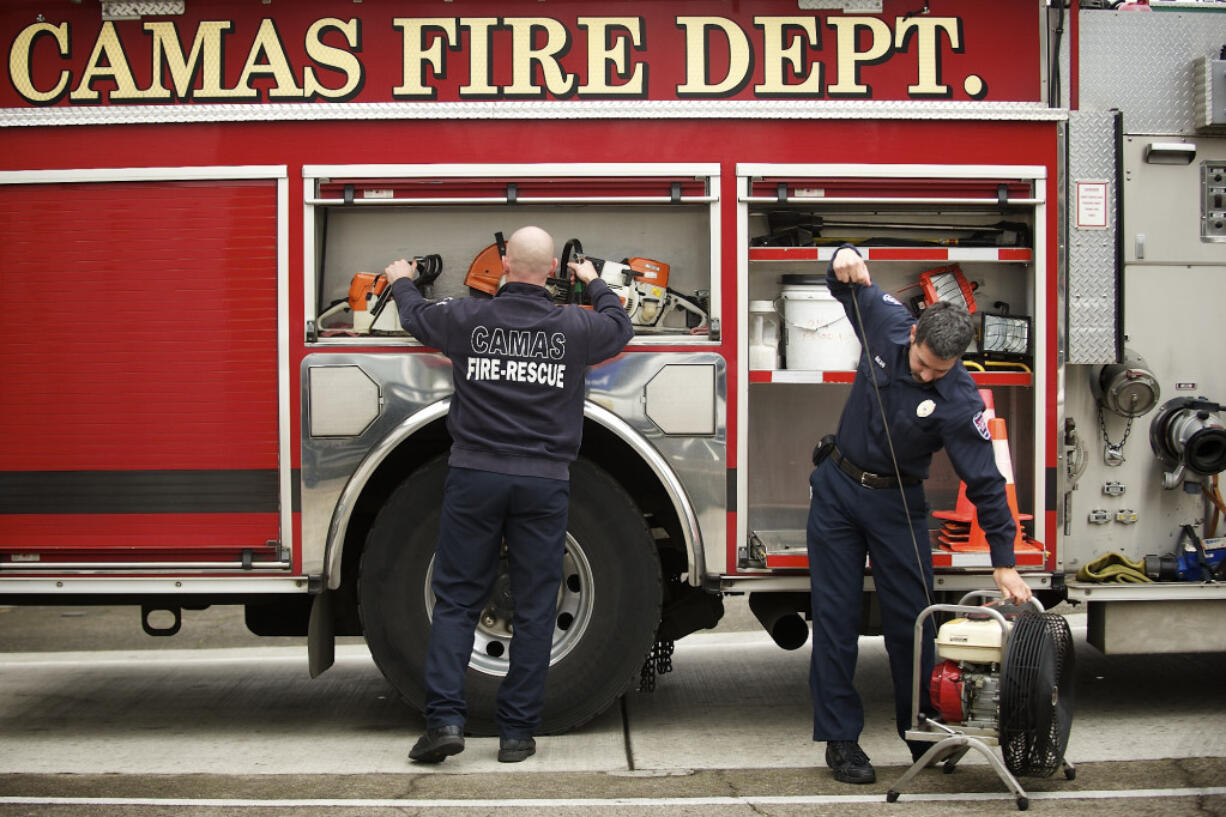 Camas-Washougal Fire Department personnel go through a routine inspection of equipment at Camas Fire Station 41.