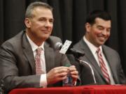 Ohio State NCAA college football head coach Urban Meyer, left, answers questions during a news conference announcing his retirement Tuesday, Dec. 4, 2018, in Columbus, Ohio. At right is assistant coach Ryan Day.