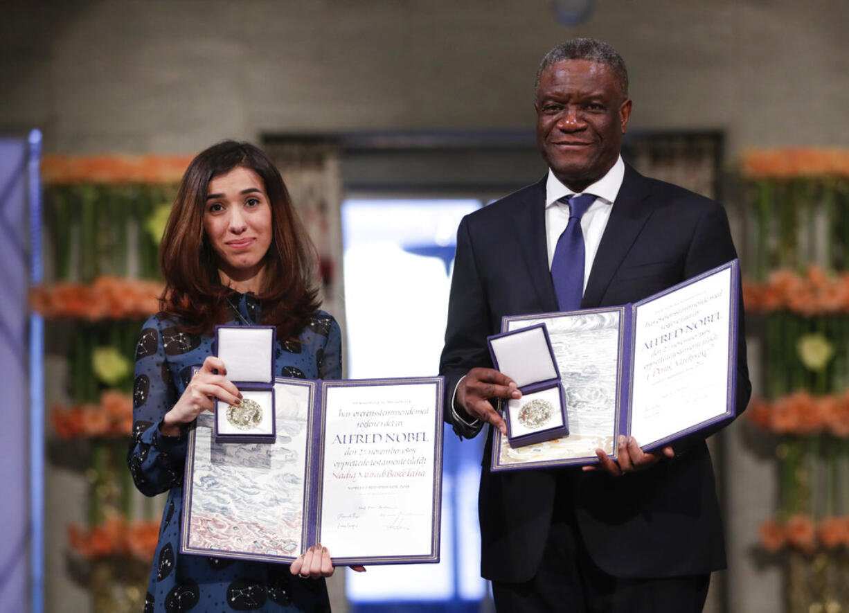 The Peace Prize laureates Dr. Denis Mukwege from Congo and Nadia Murad from Iraq, left, pose with their medals during the Nobel Peace Prize Ceremony in Oslo Town Hall, Oslo, Monday Dec. 10, 2018.  Dr. Denis Mukwege and Nadia Murad receive the Nobel Peace Prize recognising their efforts to end the use of sexual violence as a weapon of war and armed conflict.