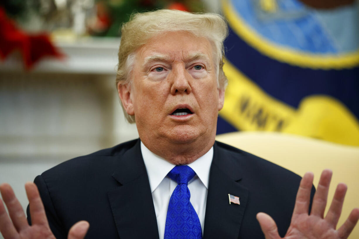 In this Dec. 11, 2018 photo, President Donald Trump speaks during a meets with Democratic leaders the Oval Office in Washington. Trump said last week he would be "proud" to have a shutdown to get Congress to approve a $5 billion down payment to fulfill his campaign promise to build a border wall.