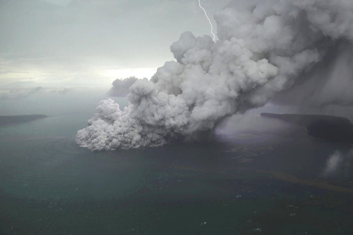 This aerial shot taken on Sunday, Dec. 23, 2018, shows volcanic material spew from the crater of Mount Anak Krakatau as it erupts on Java Strait, Indonesia. Doctors worked to save injured victims while hundreds of military and volunteers scoured debris-strewn beaches in search of survivors Monday, Dec. 24, 2018, after a deadly tsunami that followed an eruption and apparent landslide the volcano, one of the world's most infamous volcanic islands, gushed ashore without warning on Indonesian islands, killing hundreds of people on a busy holiday weekend.