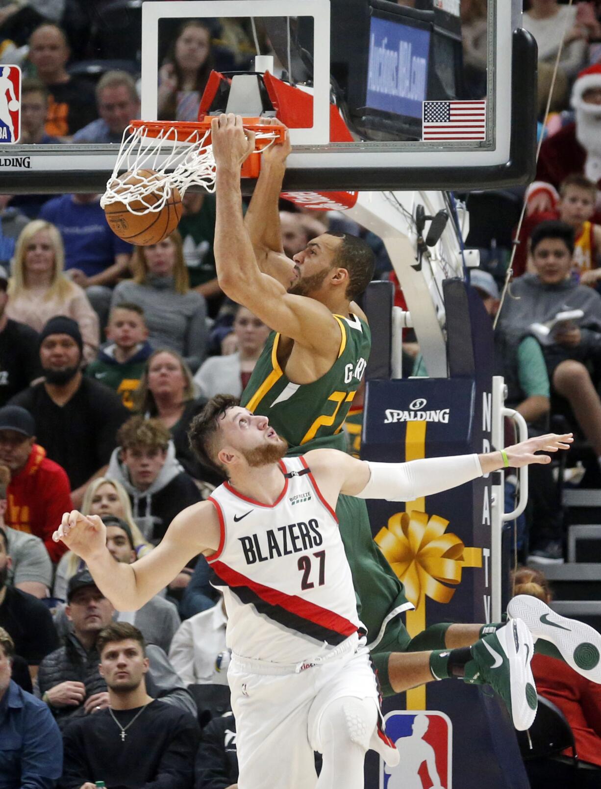 Utah Jazz center Rudy Gobert, rear, dunks on Portland Trail Blazers center Jusuf Nurkic (27) during the second half of an NBA basketball game Tuesday, Dec. 25, 2018, in Salt Lake City.