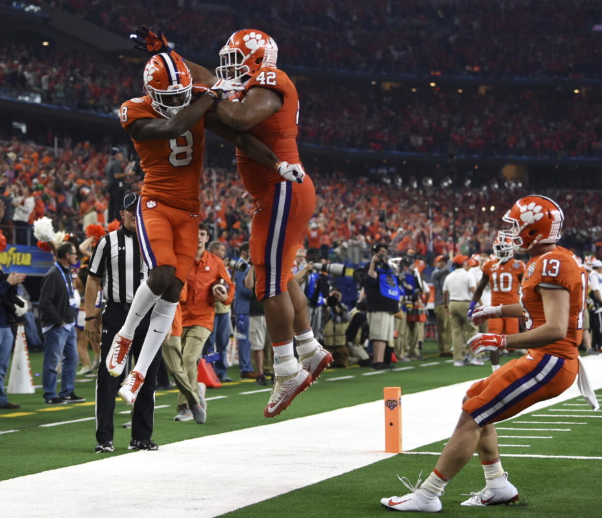 Clemson wide receiver Justyn Ross (8), defensive lineman Christian Wilkins (42) and wide receiver Hunter Renfrow (13) celebrates touchdown scored by Ross in the first half of the NCAA Cotton Bowl semi-final playoff football game against Notre Dame on Saturday, Dec. 29, 2018, in Arlington, Texas.