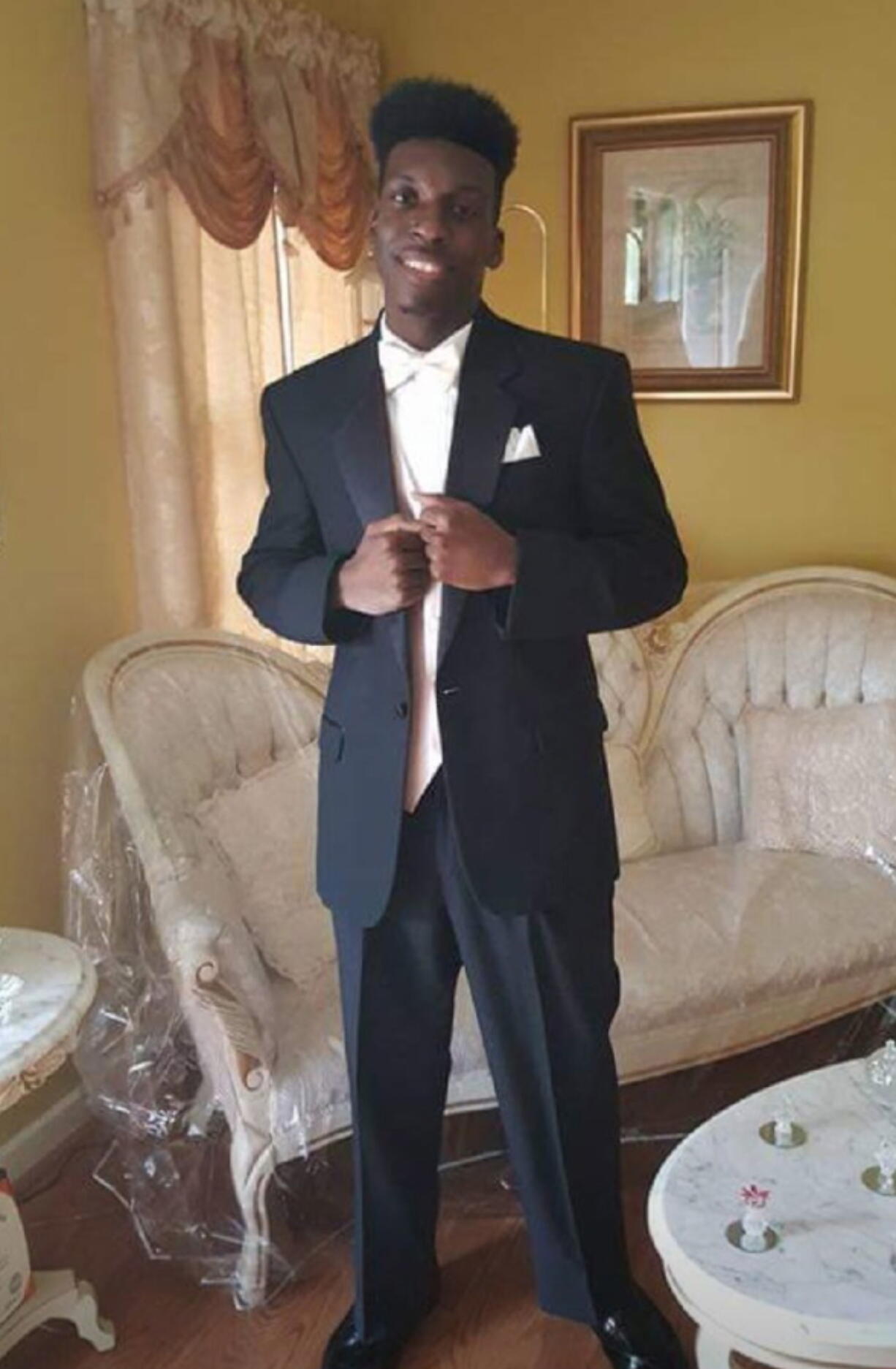 This undated image provided by Emantic Bradford, Sr. shows Emantic Fitzgerald Bradford, Jr., 21, posing for a picture at his father's home near Birmingham, Ala., in his senior year of high school. About 200 people marched through an Alabama shopping mall to protest Bradford Jr.'s death, whom police erroneously believed was the gunman who shot and wounded two people. The protesters gathered at the spot at the mall in suburban Birmingham where he was shot and killed after reports of gunfire. Police initially thought Bradford Jr. was responsible for shooting two people but later retracted that statement. (Emantic Bradford, Sr.