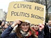 A demonstrator holds a placard which reads ‘climate first, politics second’ during a ‘Claim the Climate’ march in Brussels, Sunday, Dec. 2, 2018. The climate change conference, COP24, will take place in Poland from Dec. 2-14.