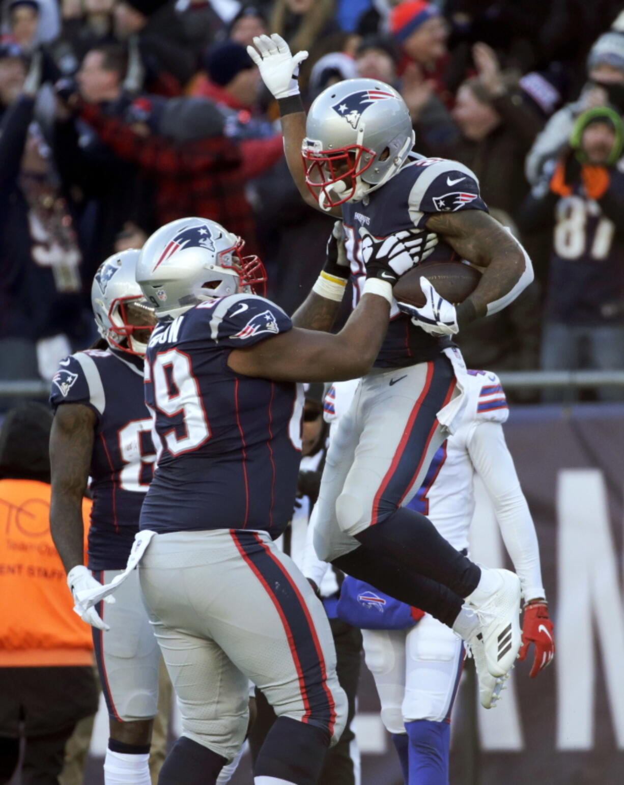 New England Patriots running back James White, right, celebrates his touchdown run with lineman Shaq Mason during the first half of an NFL football game against the Buffalo Bills, Sunday, Dec. 23, 2018, in Foxborough, Mass.